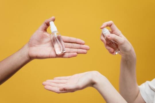 Photo of hands and hand sanitizers Photo of hands and hand sanitizers